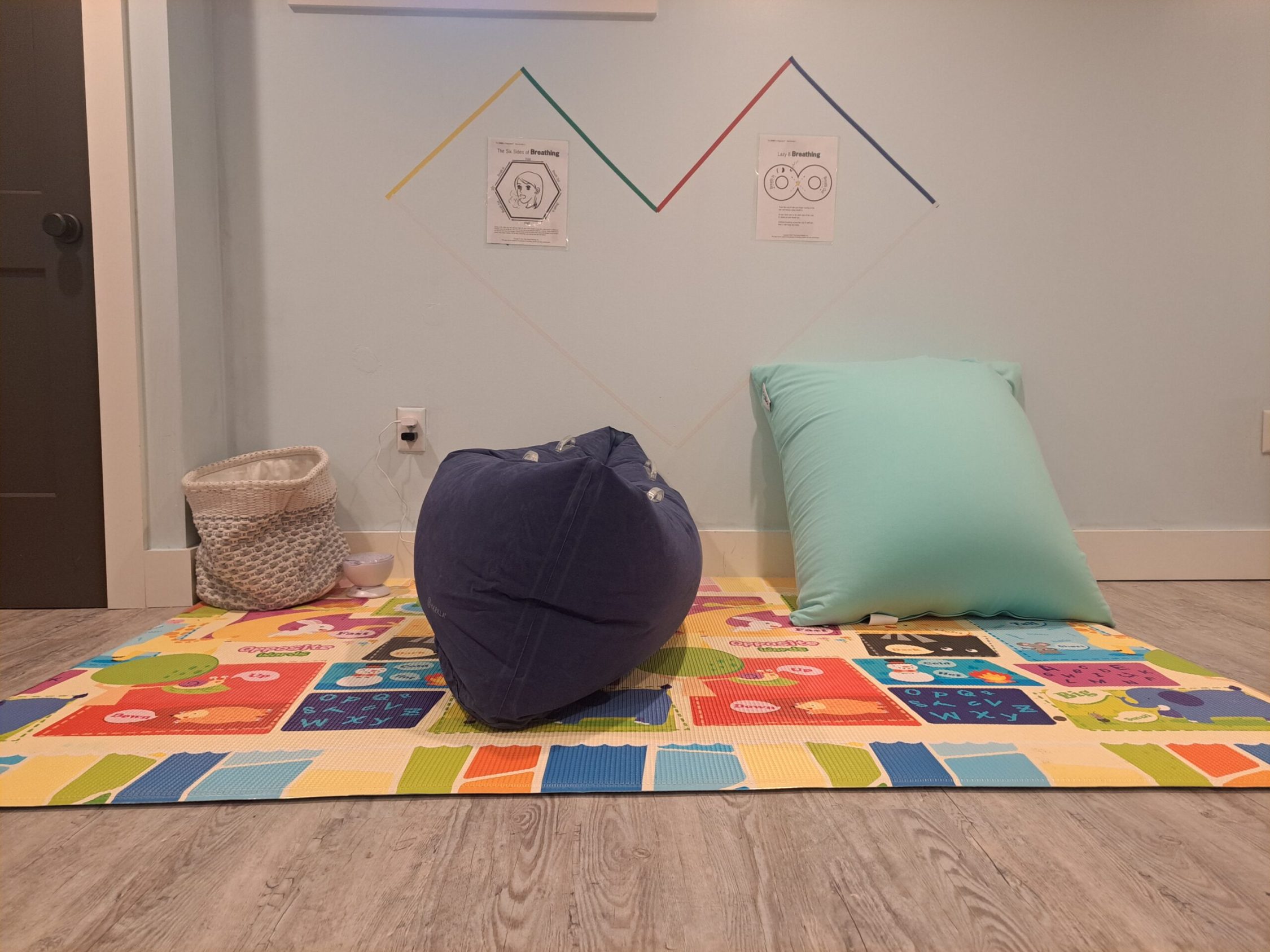 Children's sensory playroom with colorful mat and bean bag
