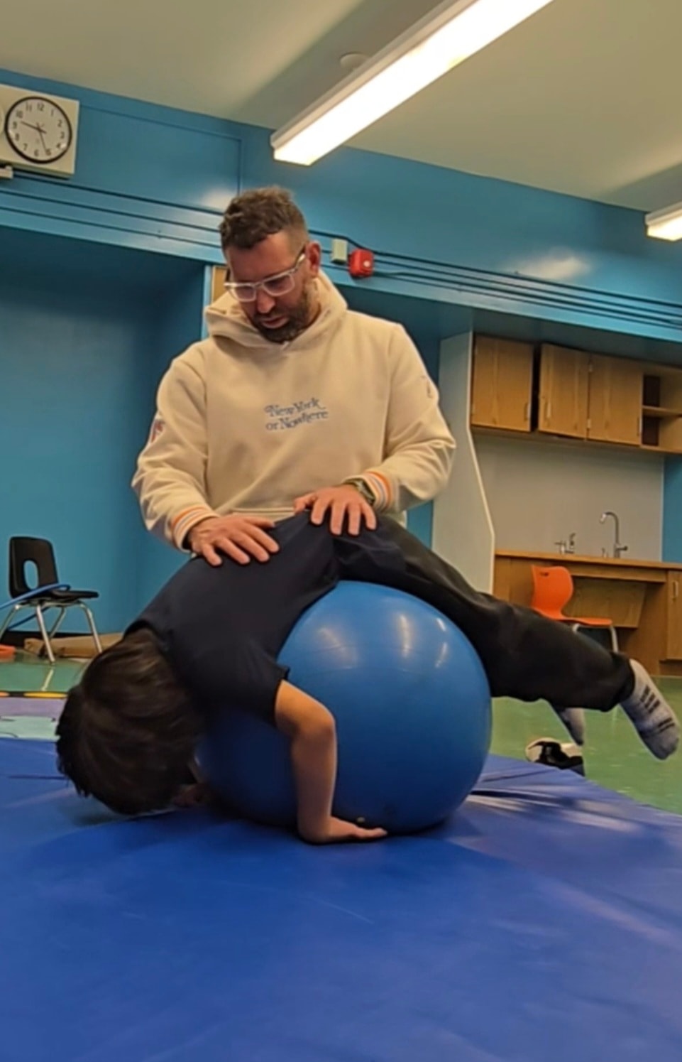 Petros Chalkitis working with a child on a therapy ball